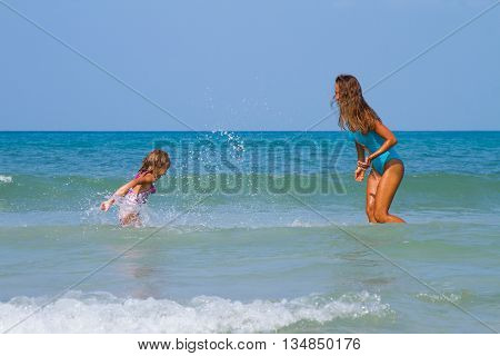 Mum with daughter on the beach in Thailand