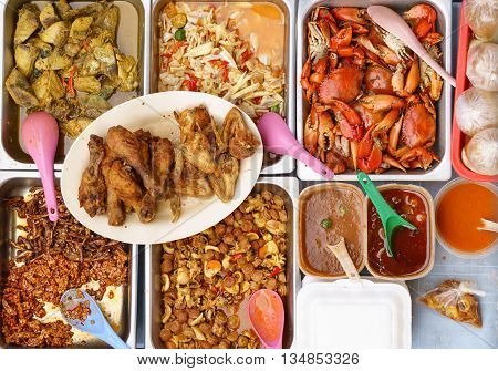 Variety of delicious Malaysian home cooked dishes sold at street market stall in Kota Kinabalu Sabah from top angle view.