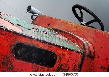 Old fashioned Rustic Tractor with steering wheel and horn