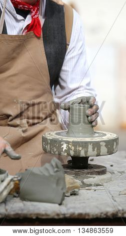Potter During Production Of A Pot With Clay