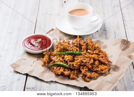 Samosa snack with tomato ketchup and hot tea, Fresh samosas with ketchup and hot chai ready for breakfast