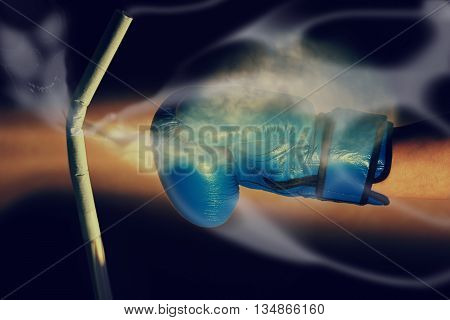 Boxing glove punching cigarette on a black background