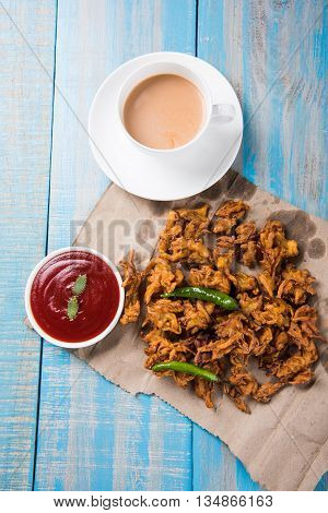 Samosa snack with tomato ketchup and hot tea, Fresh samosas with ketchup and hot chai ready for breakfast