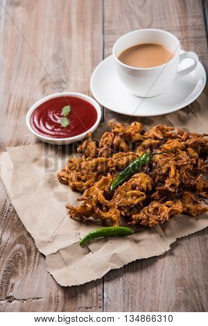 Samosa snack with tomato ketchup and hot tea, Fresh samosas with ketchup and hot chai ready for breakfast