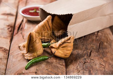 Samosa snack with tomato ketchup and hot tea, Fresh samosas with ketchup and hot chai ready for breakfast