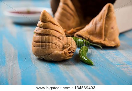 Samosa snack with tomato ketchup and hot tea, Fresh samosas with ketchup and hot chai ready for breakfast
