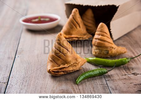 Samosa snack with tomato ketchup and hot tea, Fresh samosas with ketchup and hot chai ready for breakfast