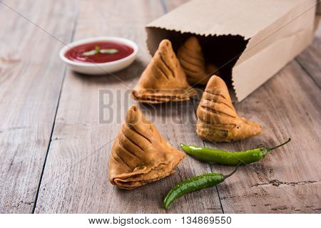 Samosa snack with tomato ketchup and hot tea, Fresh samosas with ketchup and hot chai ready for breakfast