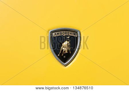 TURIN, ITALY - JUNE 9, 2016: Old Lamborghini logo on a yellow Miura car model