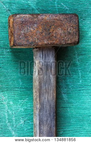 Old reliable tool for dismantling lying on a wooden surface. Proven remedy for hard action.