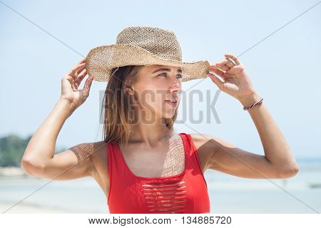 Woman on the beach with straw hat