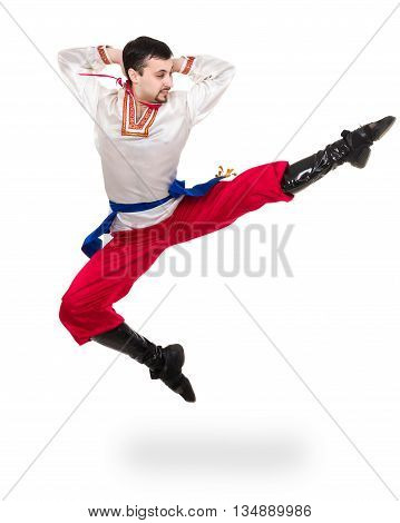 young man wearing a folk costume jumping against isolated white background with copyspace
