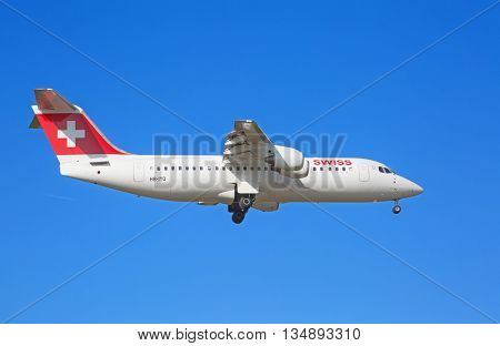 ZURICH - JULY 18: AVRO RJ100 landing in Zurich airport after short haul flight on July 18, 2015 in Zurich, Switzerland. Zurich airport is home port for Swiss Air and one of the biggest european hubs.