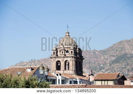 Church tower rising above city roof tops