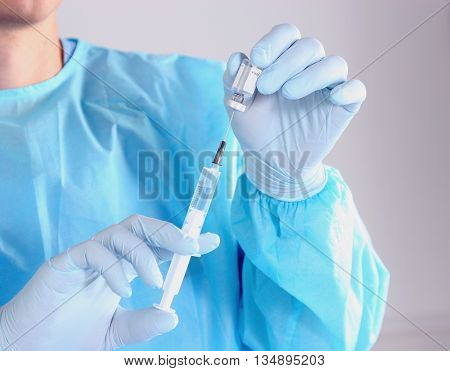 Doctor in blue uniform holding X-rays. clinic