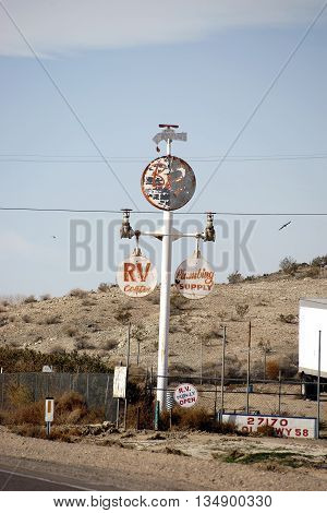 BARSTOW, UNITED STATES - DECEMBER 22: The Retro and Vintage sign of a sales shop for plumbing accessories in the desert on December 22, 2015 in Barstow.