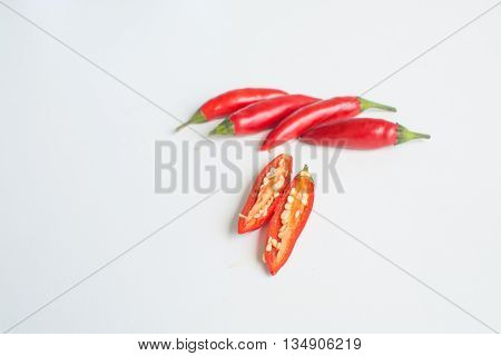 Bright red hot birdseye chili peppers on white background