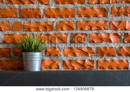 Fake grass in cans and wall in coffee shop