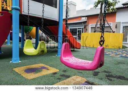 pink swings at playground for kid in the park