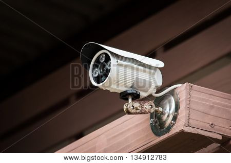 closed video circuit camera on wooden background
