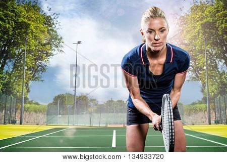 Tennis player playing tennis with a racket against composite image of tennis field on a sunny day