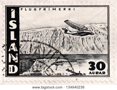 LUGA RUSSIA - APRIL 12 2016: A stamp printed by ICELAND shows Flying Boat over Skutulsfjordur - a big fjord in the north side of the Westfjords. It surrounds the town of Isafjordur circa 1947