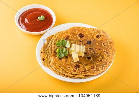 Hot delicious paratha with ghee and tomato sauce