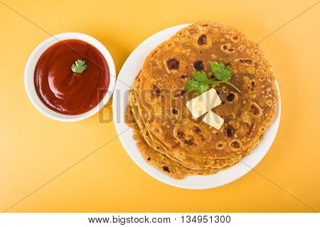 Hot delicious paratha with ghee and tomato sauce