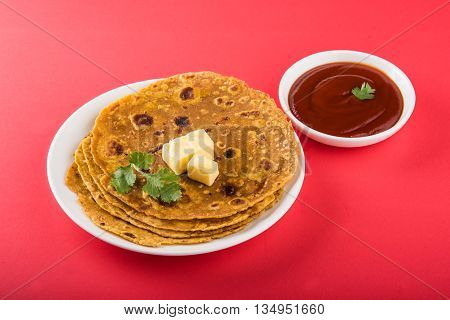 Hot delicious paratha with butter and tomato sauce