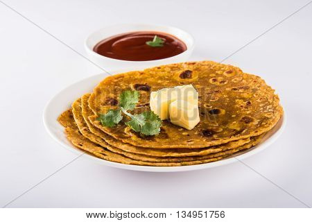 Hot delicious paratha with ghee and tomato sauce