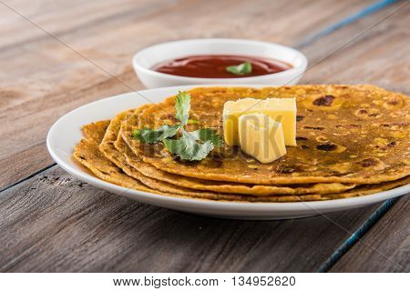 Hot delicious paratha with ghee and tomato sauce