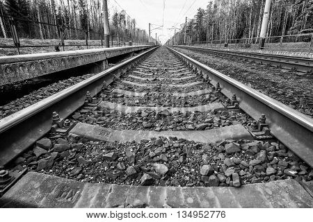 Parallel to the railway tracks at a station in the countryside