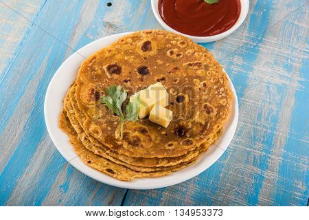 Hot delicious paratha with ghee and tomato sauce