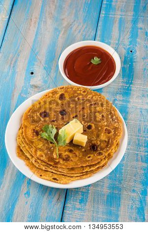 Hot delicious paratha with ghee and tomato sauce