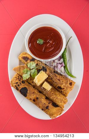 Hot delicious paratha with ghee, green chilly, coriander and tomato sauce. Paratha Rolls. Chapati made using indian spices. Kolkata rolls