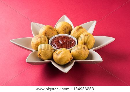 aalu bonda or aalo bonda or batata vada, indian tasty snack tastes great with tea, tea time snack, served with red tomato sauce