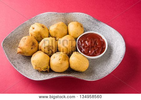 indian snacks also known as urad daal vada or indian pakoda or couth indian pakora or batata vada or aalu bonda or aalu bonde