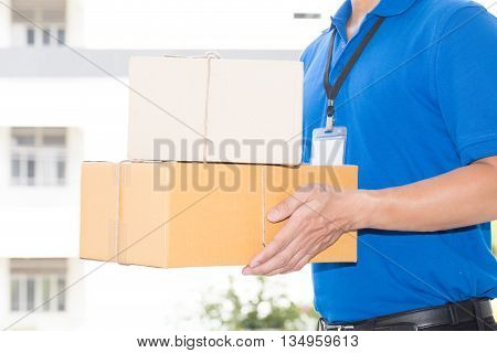 Delivery man holding a parcel box for sending