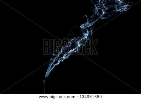 Incense aroma stick with smoke on black background