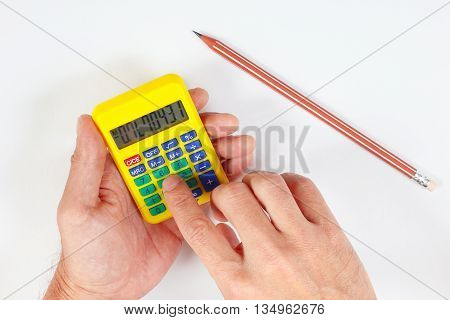 Hands calculate using a pocket digital calculator on a white background