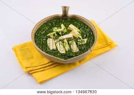 palak paneer served with naan / roti / paratha / chapati / phulka or fulka / indian bread, isolated on white background