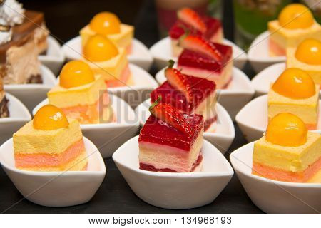 Appetizers mini desserts on catering buffet on white cup