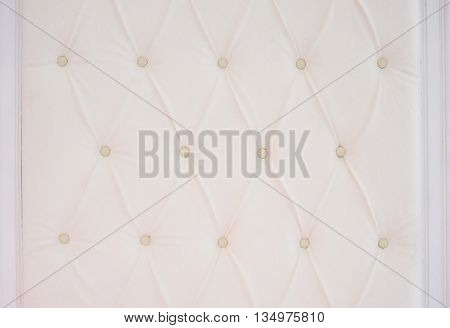 Closeup texture of vintage beige leather sofa for background.
