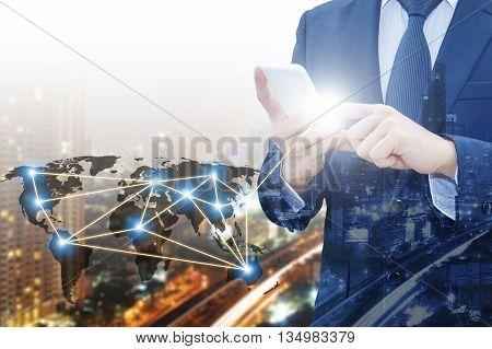 Double exposure of businessman touching with smart phone world business network connection and city center of business Technology communication business and finance concept world map from NASA