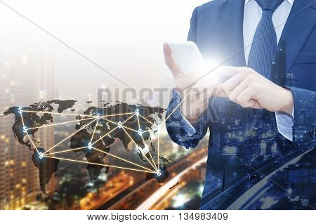 Double exposure of businessman touching with smart phone world business network connection and city center of business Technology communication business and finance concept world map from NASA