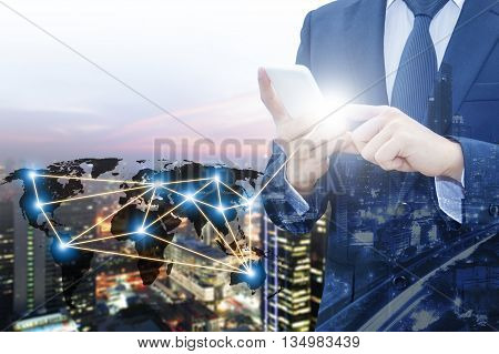 Double exposure of businessman touching with smart phone world business network connection and city center of business Technology communication business and finance concept world map from NASA