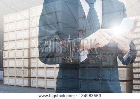 Double exposure of professional businessman using smart phone and city centre of business with blurred transportation port background Technology Transportation & Business trading concept