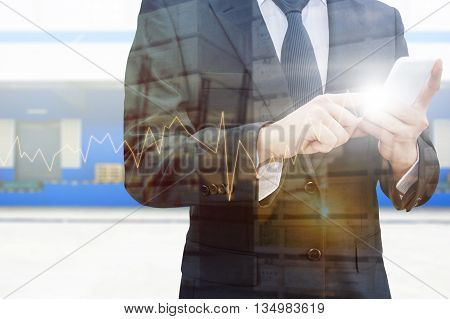 Double exposure of professional businessman using smart phone city centre of business with blurred transportation port and distribution cargo warehouse background Technology Transportation & Business trading concept