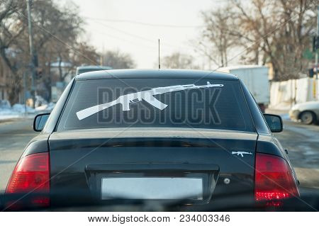 Figure Kalashnikov Rifle On The Rear Window Of The Car