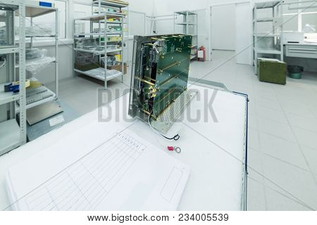 A New Electronic Module Is On The Assembly Table. Modern Production Of Electronic Devices.